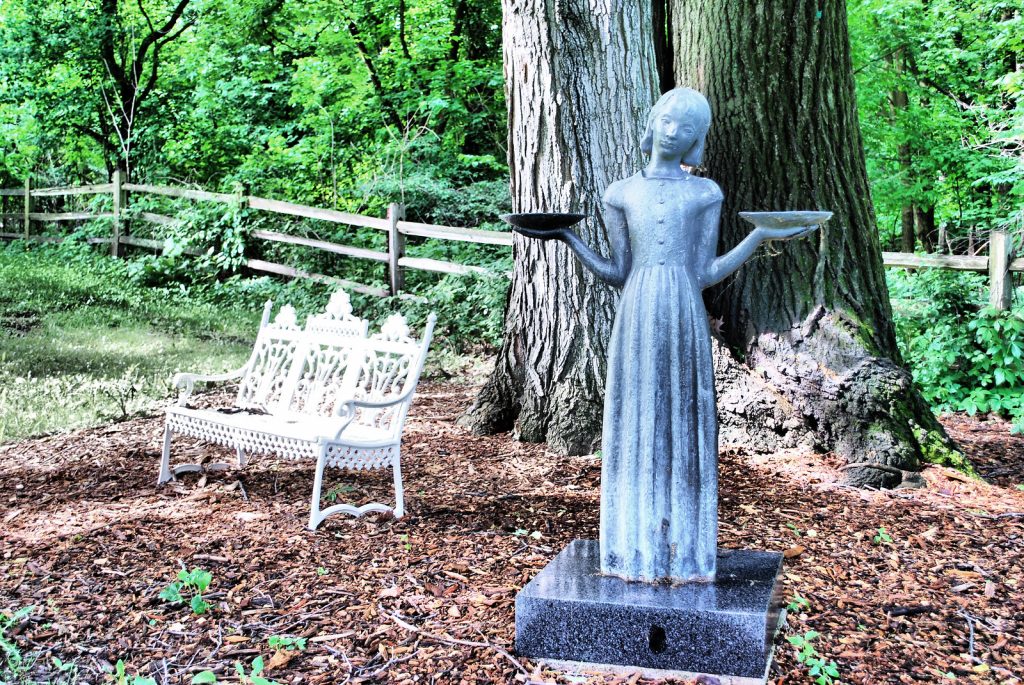 Female statue holding trays in a Savannah cemetery
