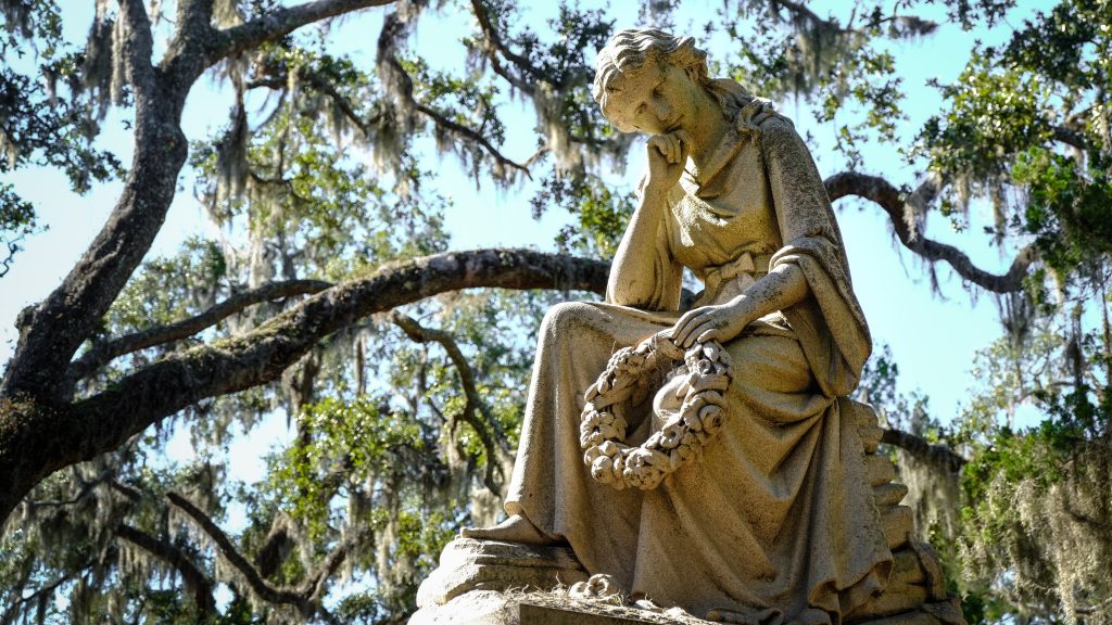 Contemplative woman statue holding a wreath in a Savannah cemetery